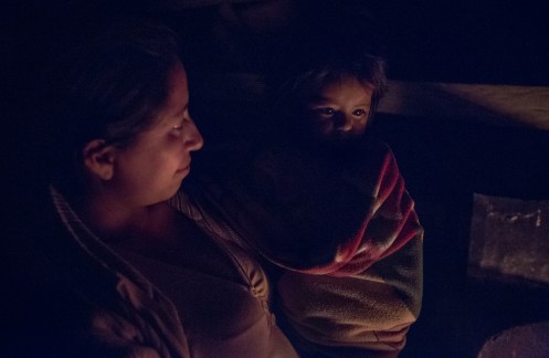 Cresencia y su hija frente al fuego mientras compartimos la noche con historias.